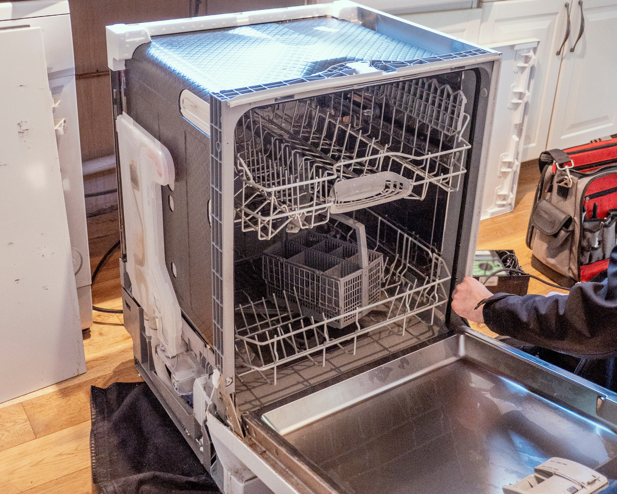 open dishwasher being repaired